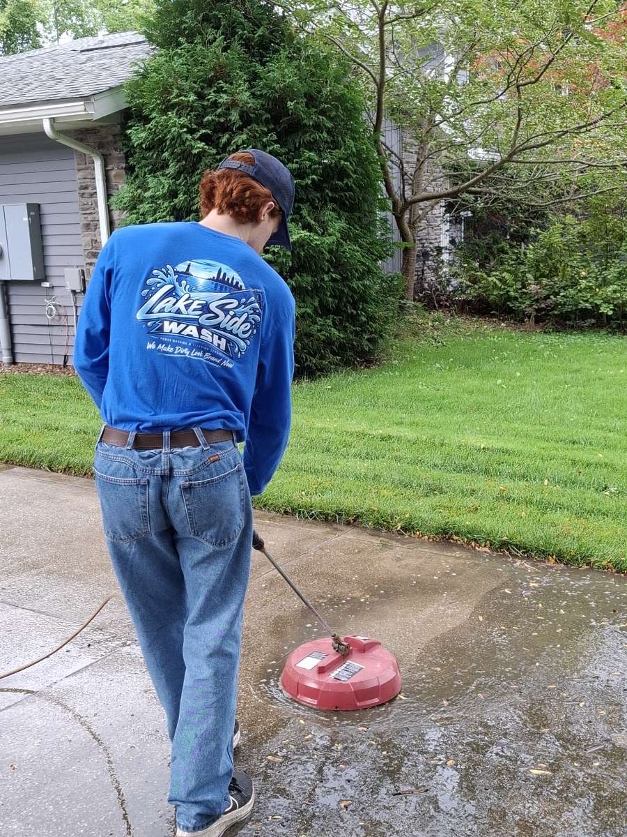 Lake Side Wash surface cleaning a driveway beside a stone-front house